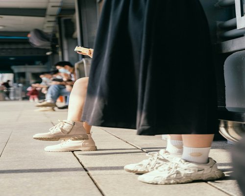 Person wearing comfortable shoes stepping off a bus in the city